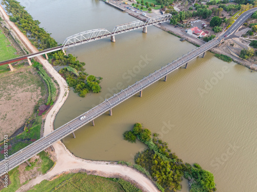 Aerial view of bridges crossing a wide brown river photo