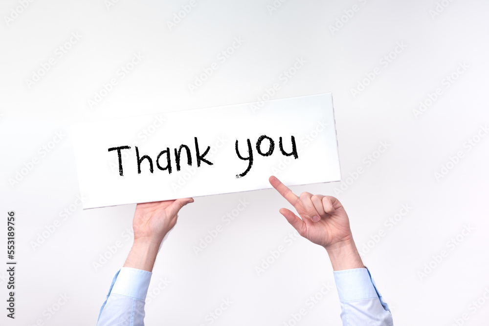 two hands hold up a sign that says thank you two hands hold up a sign that says thank you