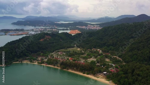 Drone forward flying capturing Teluk Batik beach with marina island and damar laut in the background, straits of malacca, Lumut, Perak, Malaysia, Southeast Asia. photo