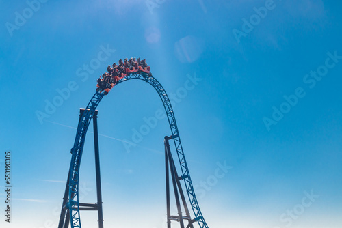 Ride roller coaster in blurred motion on sky background in amusement park © Elena Noeva