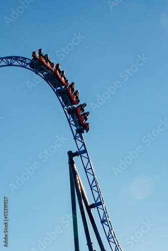 Ride roller coaster in blurred motion on sky background in amusement park
