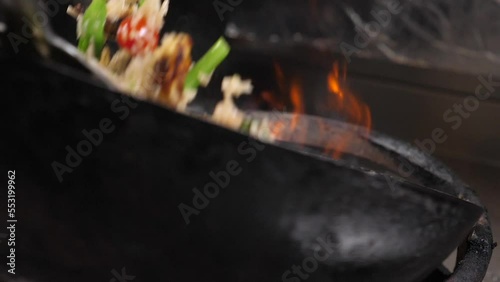 close up of fried rice with vegetables and meat in a wok