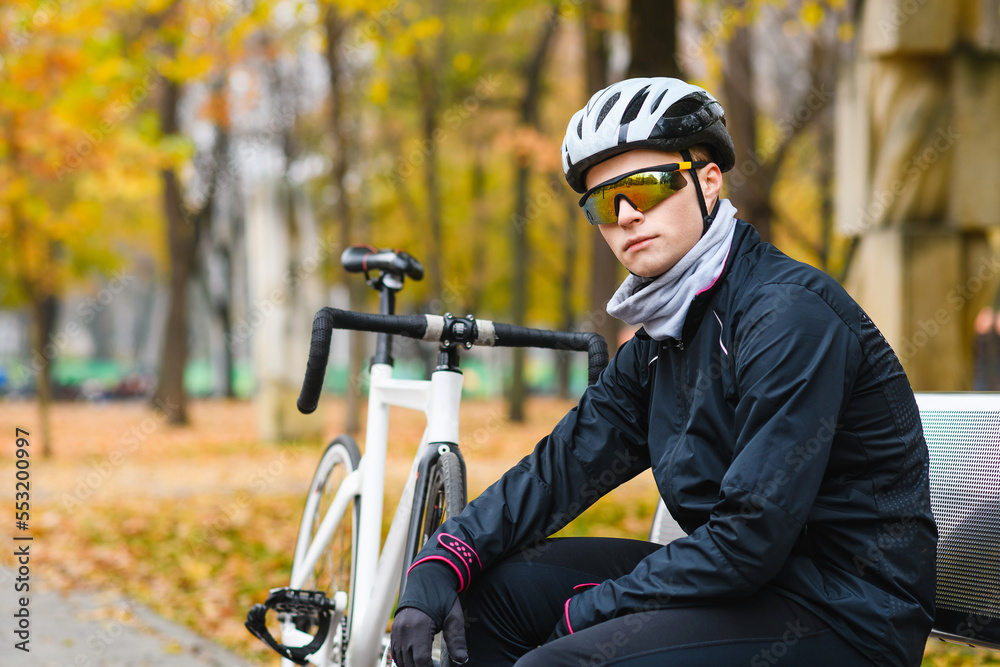 Portrait of young bicyclist with bike outdoors