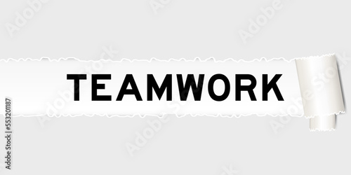 Ripped gray paper background that have word teamwork under torn part