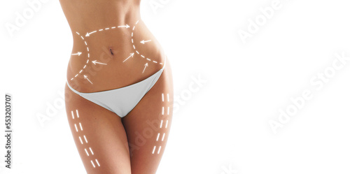 Fotobehang Beautiful woman with slim and sporty body in swimwear having arrows along her stomach and legs