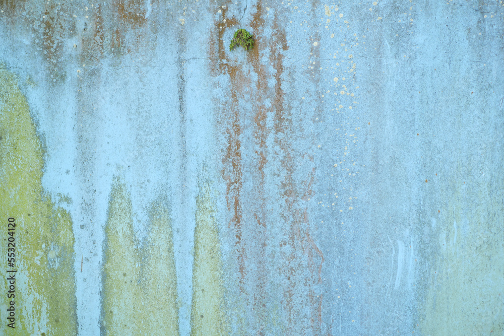 old wooden plank wall with old faded peeling green, yellow paint