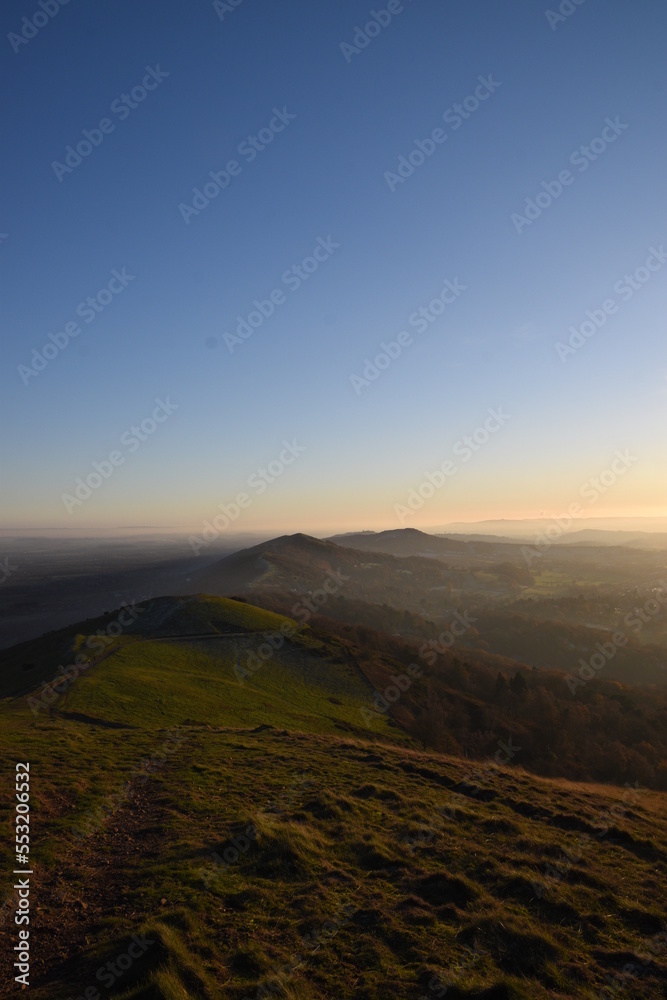 the top of the Malvern hills on a misty day during sunset