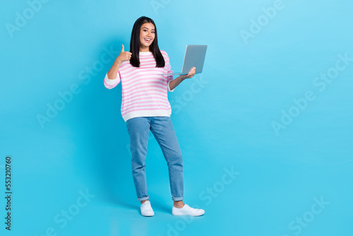 Full body size photo of young entrepreneur it developing company owner thumb up hold computer like new app isolated on blue color background