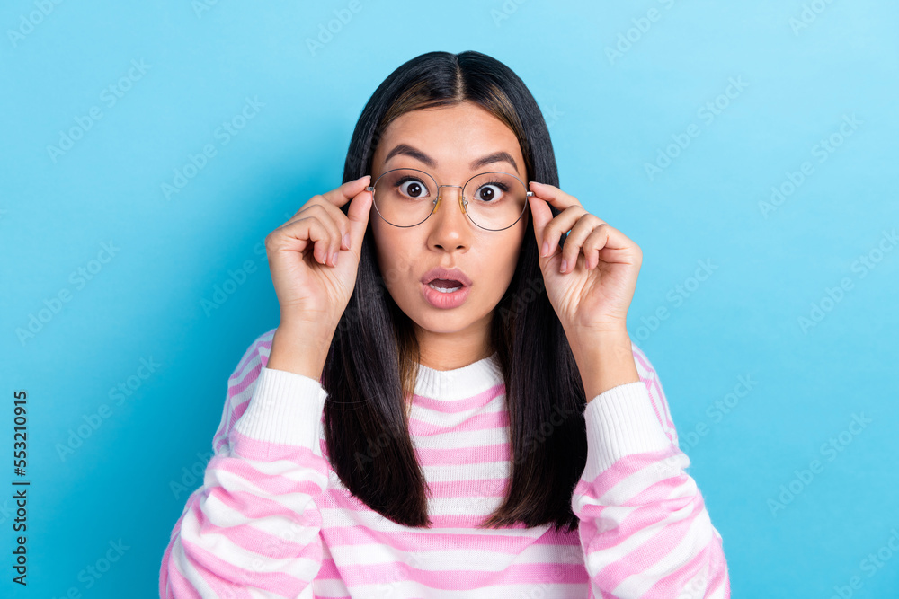 Photo of impressed shocked girl dressed pink pullover arms eyewear big eyes isolated blue color background Photo of impressed shocked girl dressed pink pullover arms eyewear big eyes isolated blue color background