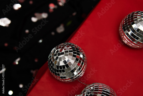 silver mirror balls on red gifts and black background
