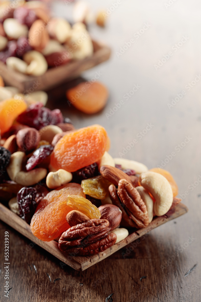 Mix of nuts and dried fruits on an old wooden table. Mix of nuts and dried fruits on an old wooden table.