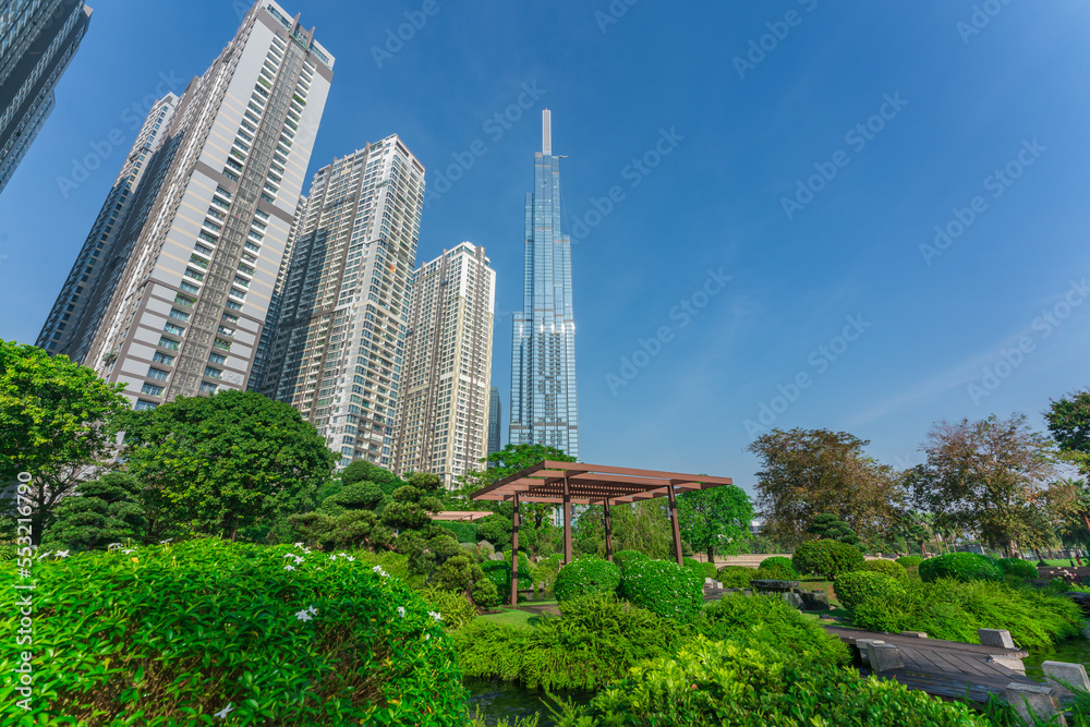Fototapeta premium Landmark 81, skyscrapers viewed from below towards sky represents urban development with modern architecture. Combined with Vinhomes Central Park Project