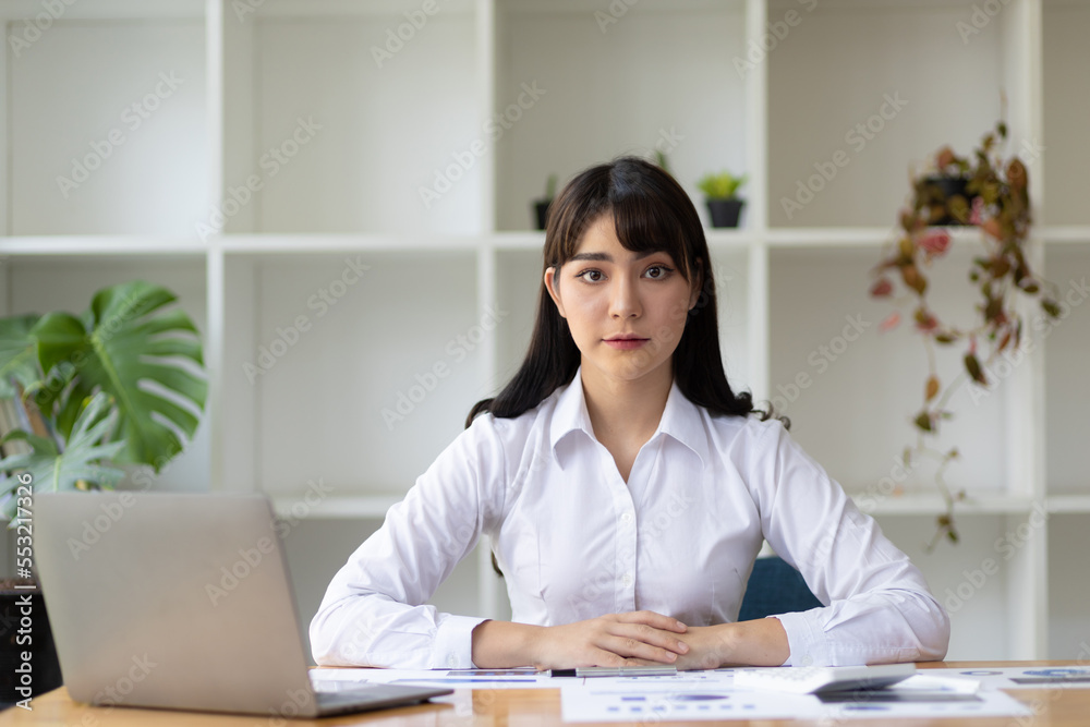 Portrait of attractive Asian businesswoman working at desk in office. Portrait of attractive Asian businesswoman working at desk in office.