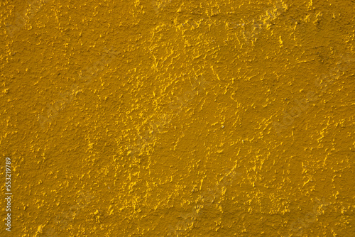 Golden yellow colored abstract wall background with textures of different shades of yellow