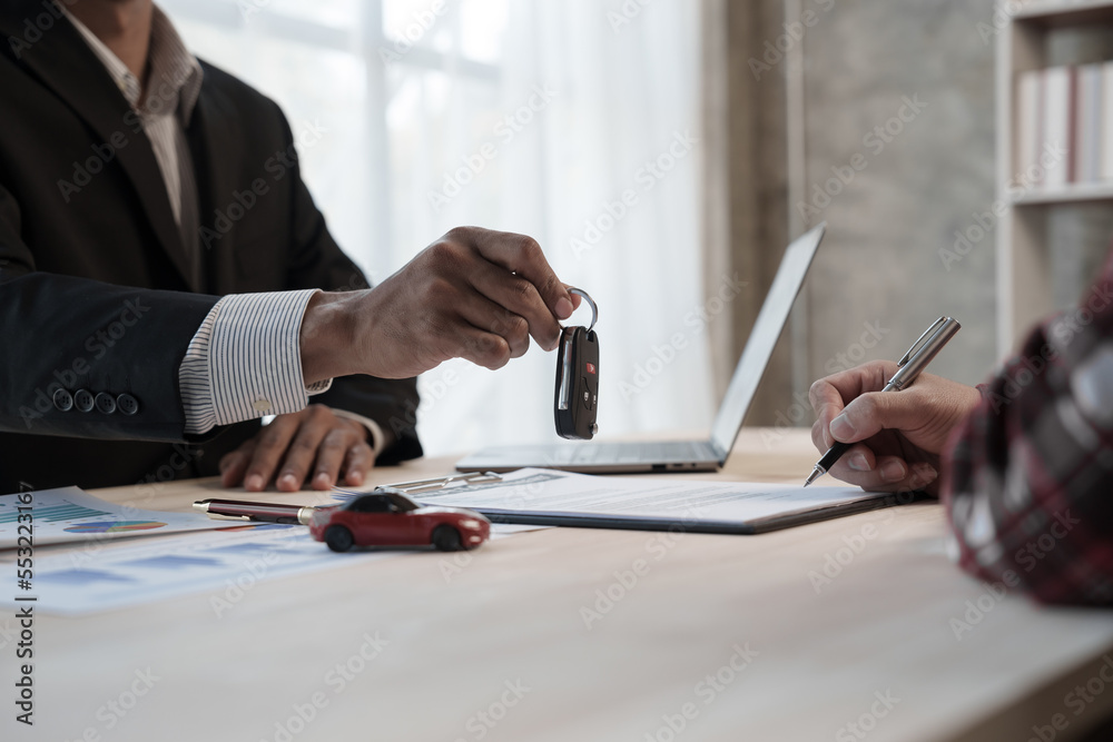 Loan approver, businessman in suit, man giving car keys after car loan