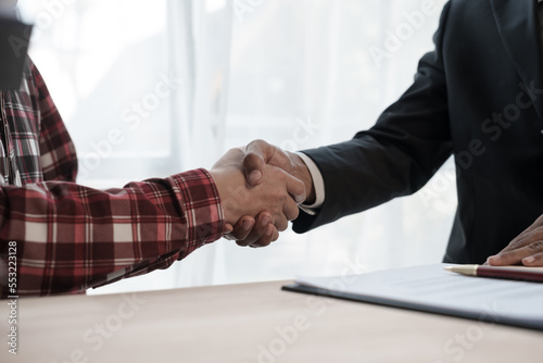 Shaking hands, Credit approver, businessman in male suit and house toy model mockup Home loan mortgage approval concept. After signing the contract photo