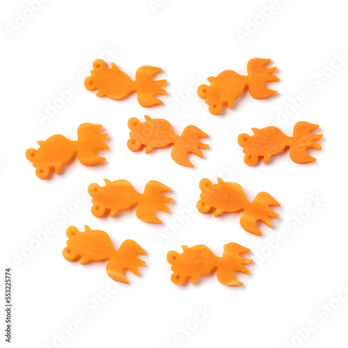 Collection of cut out goldfishes from fresh raw sweet winter carrots with a mold isolated on white background