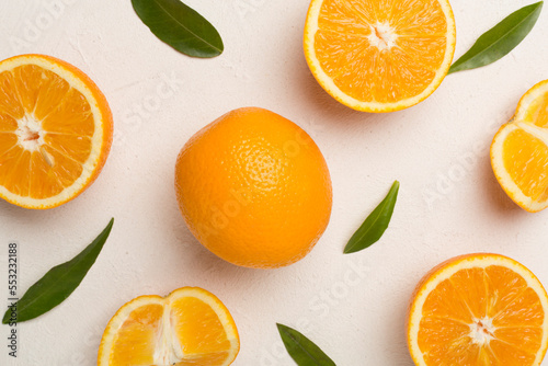 Fresh oranges with leaves on concrete background