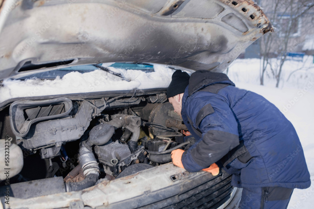 truck van car driver fixing the car in winter on the road. Delivery car breakdown in winter truck van car driver fixing the car in winter on the road. Delivery car breakdown in winter