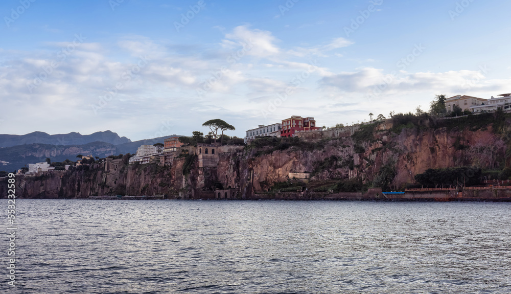 Homes and Hotels in a touristic town on the seafront. Sorrento, Compania, Italy. Colorful Cloudy Sky Art Render.