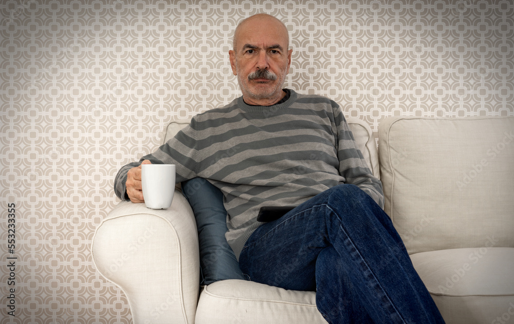 Old Man Sitting at Sofa and Drinking Coffee from Mug Old Man Sitting at Sofa and Drinking Coffee from Mug