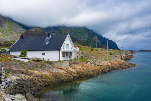 Traditional white wooden house on Engoya island, Lofoten, Norway photo