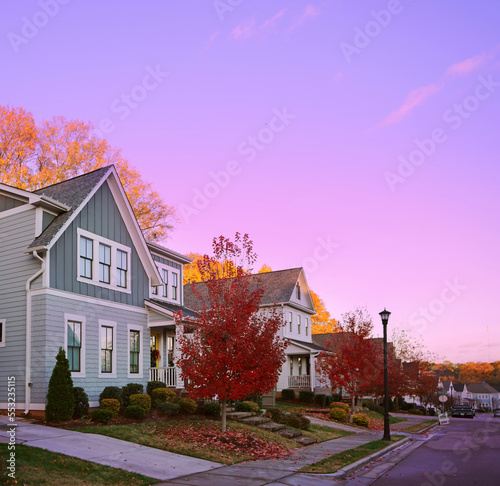 New houses on a quiet city street in Raleigh NC with colorful Fall foliage