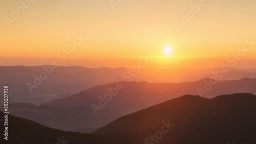 Beautiful panoramic mountain landscape on golden sunset © gilitukha