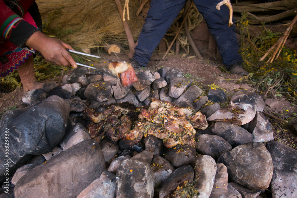 Fototapeta premium In the pachamanca ceremony, lamb, alpaca, pork and beef are cooked. Also variety of tubers and vegetables. All under hot stones and covered with earth.
