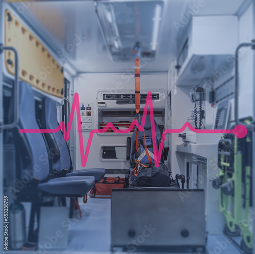 Interior of an ambulance with bed and patient care equipment. Illustration with heartbeat signal.
