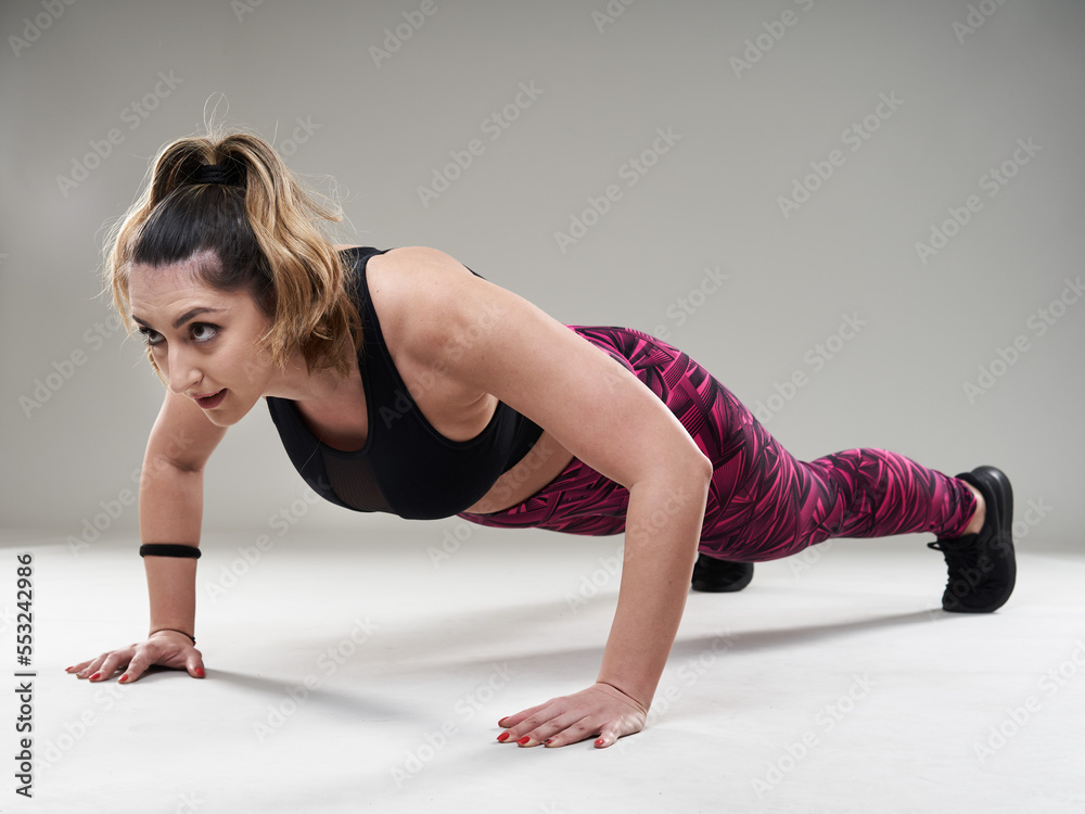 Plus size woman doing isometric exercises Plus size woman doing isometric exercises