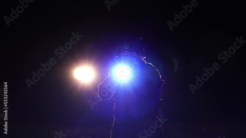 Police officer holding a gun with anti-terrorism mission at night photo