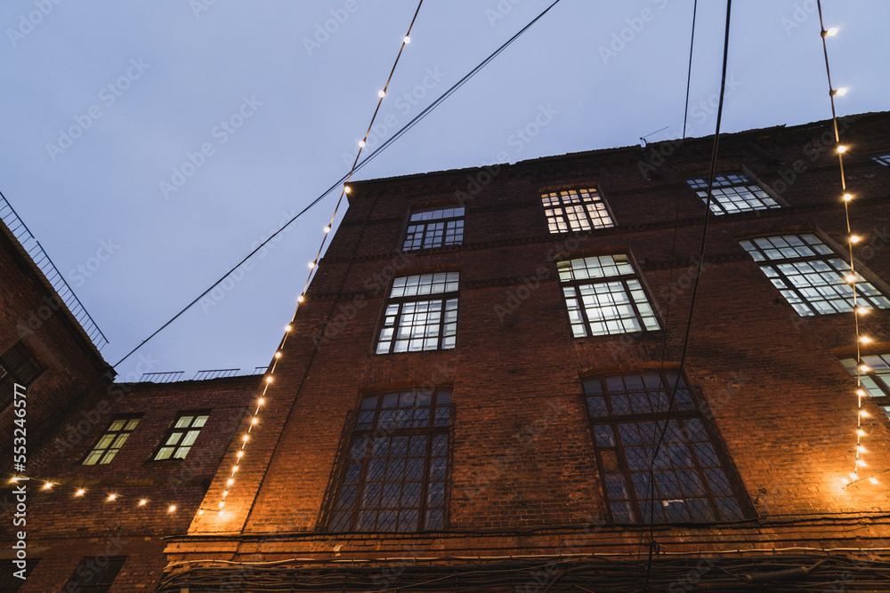 Old brick house illuminated by small lanterns Old brick house illuminated by small lanterns