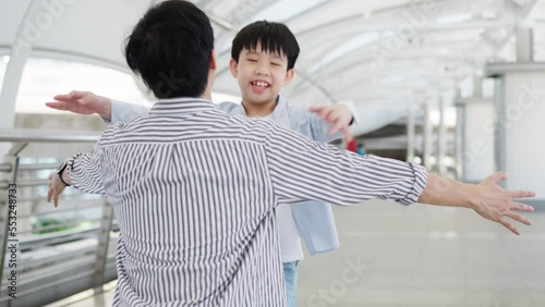 Asia little boy running and hug his father at the airport sky walk with smile on sunny day. Happy for traveling trip during vacation. Family relation father and son. Travel at the central city