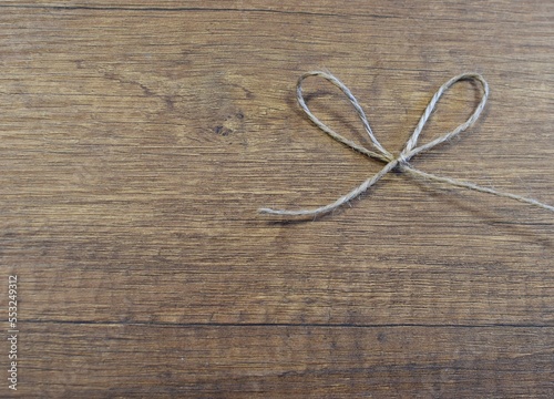 rope bow on wooden background