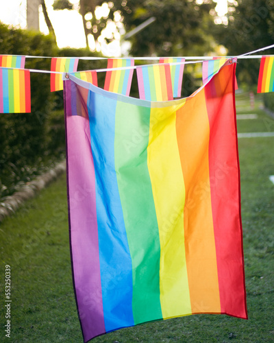 Closeup of gay PRIDE with heart shaped rainbow flag on wrist. Rainbow tattoo. LGBTQ pride month symbol. Equal rights.