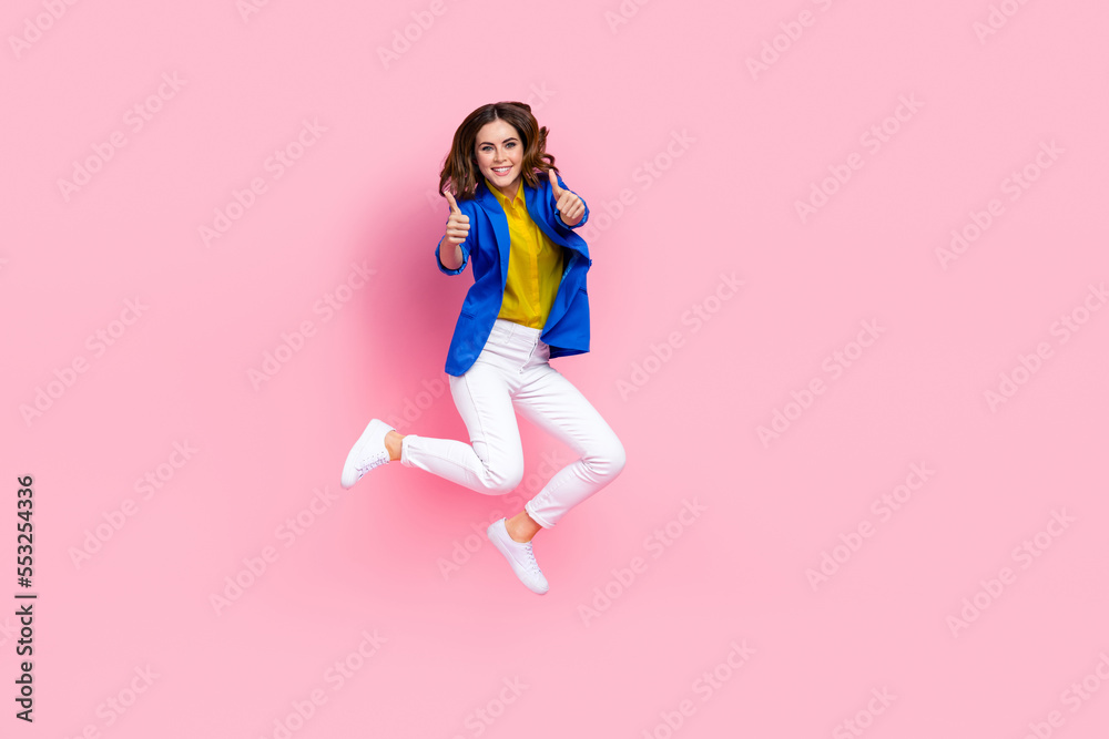 Full body photo of excited nice lady jumping hands fingers demonstrate thumb up isolated on pink color background Full body photo of excited nice lady jumping hands fingers demonstrate thumb up isolated on pink color background