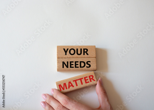 Your needs matter symbol. Wooden blocks with words Your needs matter. Beautiful white background. Businessman hand. Business andYour needs matter concept. Copy space.