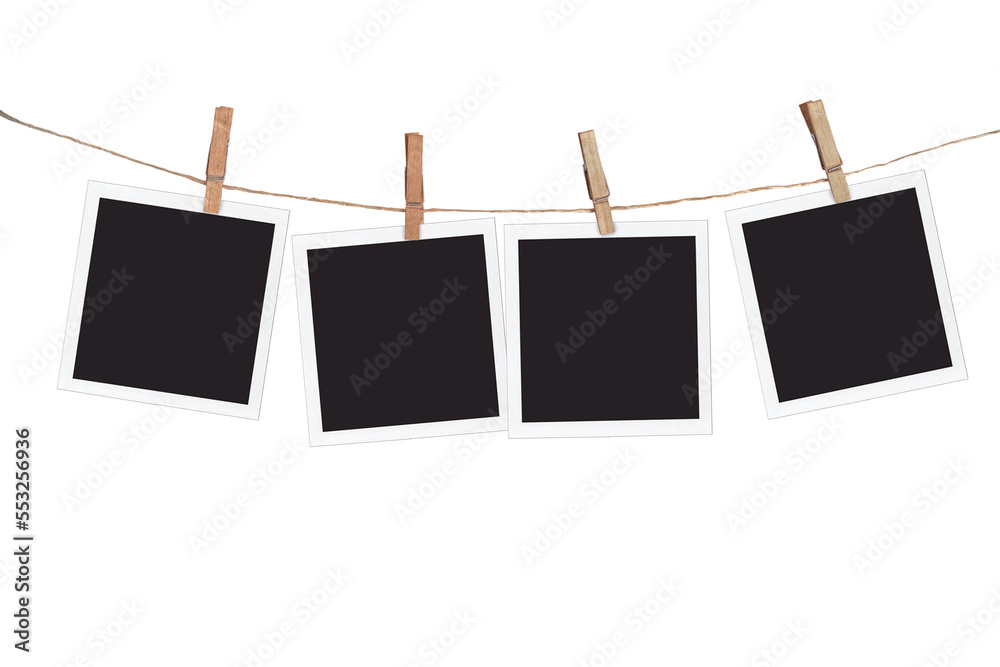 Four blank instant photo frames hanging on a rope, isolated on ...