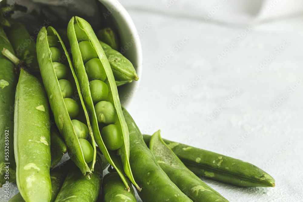 Raw green pea pods on light background Raw green pea pods on light background