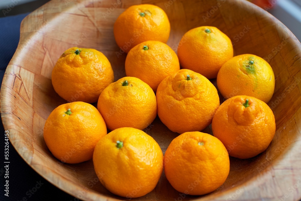 fresh garden tangerines in wooden bowl
