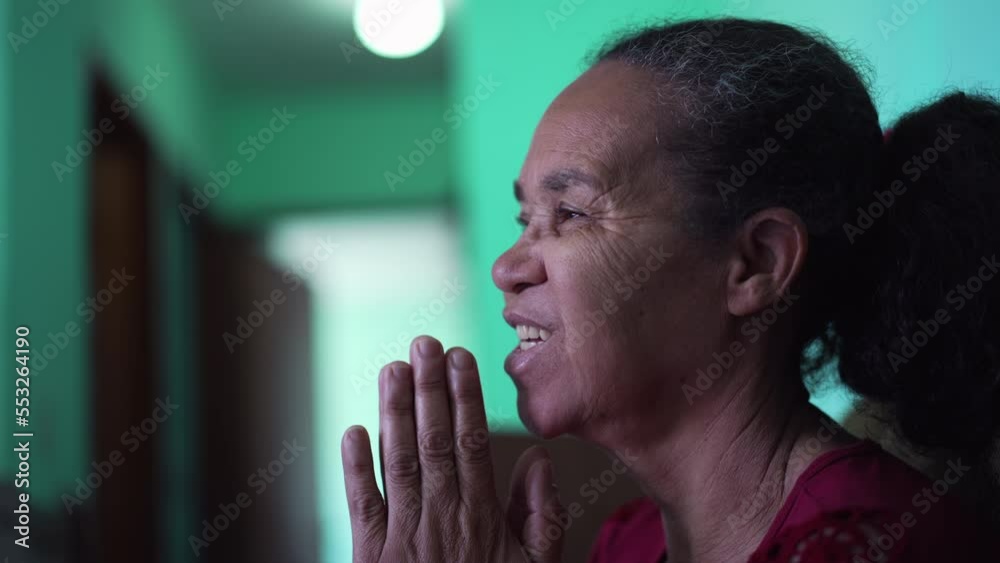 Hopeful mature hispanic senior woman praying smiling Hopeful mature hispanic senior woman praying smiling