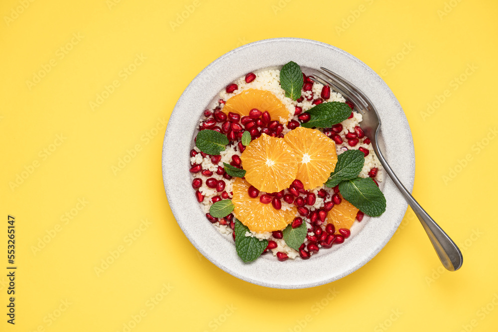 Couscous salad with oranges, pomegranate seeds and mint. Seasonal fruit salad. Middle eastern food Couscous salad with oranges, pomegranate seeds and mint. Seasonal fruit salad. Middle eastern food