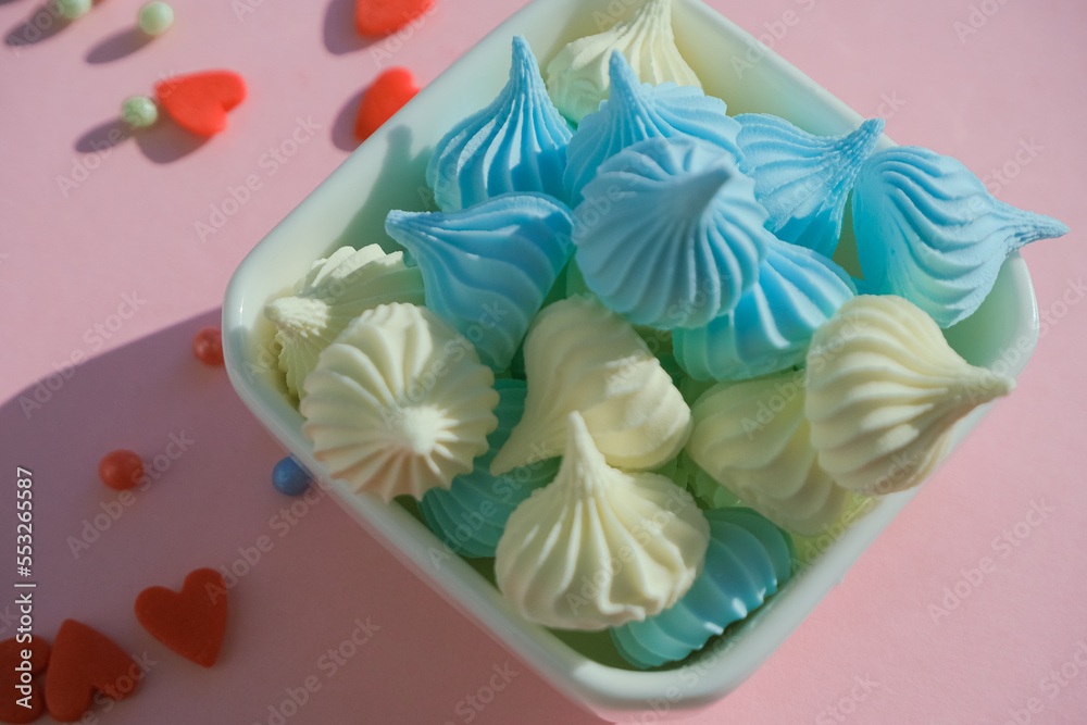 Meringue on a plate, colorful birthday background with sweets. Holiday decoration concept Meringue on a plate, colorful birthday background with sweets. Holiday decoration concept