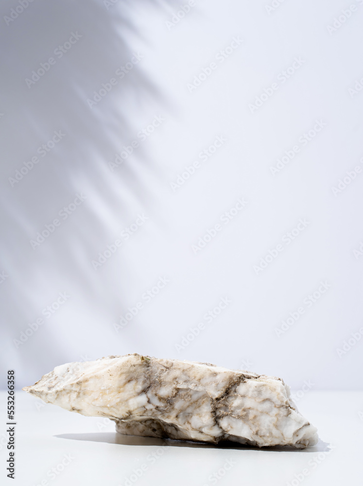 A minimalistic scene of stone marble podium on white background, for natural cosmetics