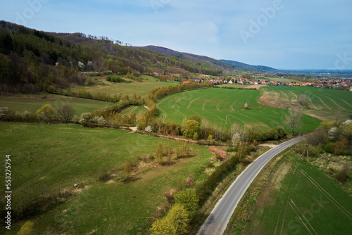 Drone flight over mountain village among green agricultural fields, Countryside view, Nature landscape