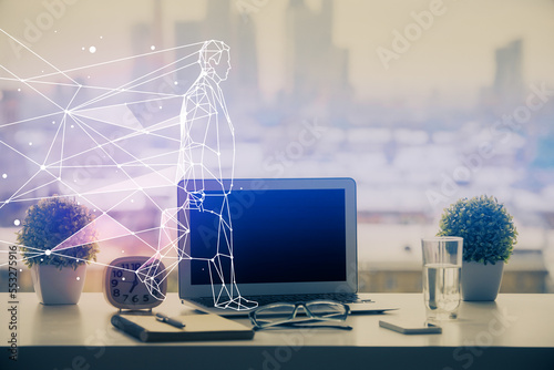 Desktop computer background in office and start up theme hologram drawing. Double exposure. Startup concept.