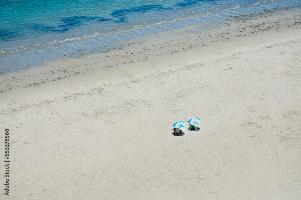 vacation couple resting on white beach sand