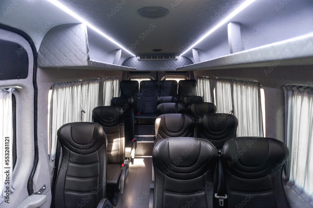 comfortable passenger bus interior with upholstered seats; individual transfer for a group of people; conversion of the interior of a truck; 