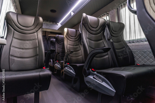 comfortable passenger bus interior with upholstered seats; individual transfer for a group of people; conversion of the interior of a truck; 